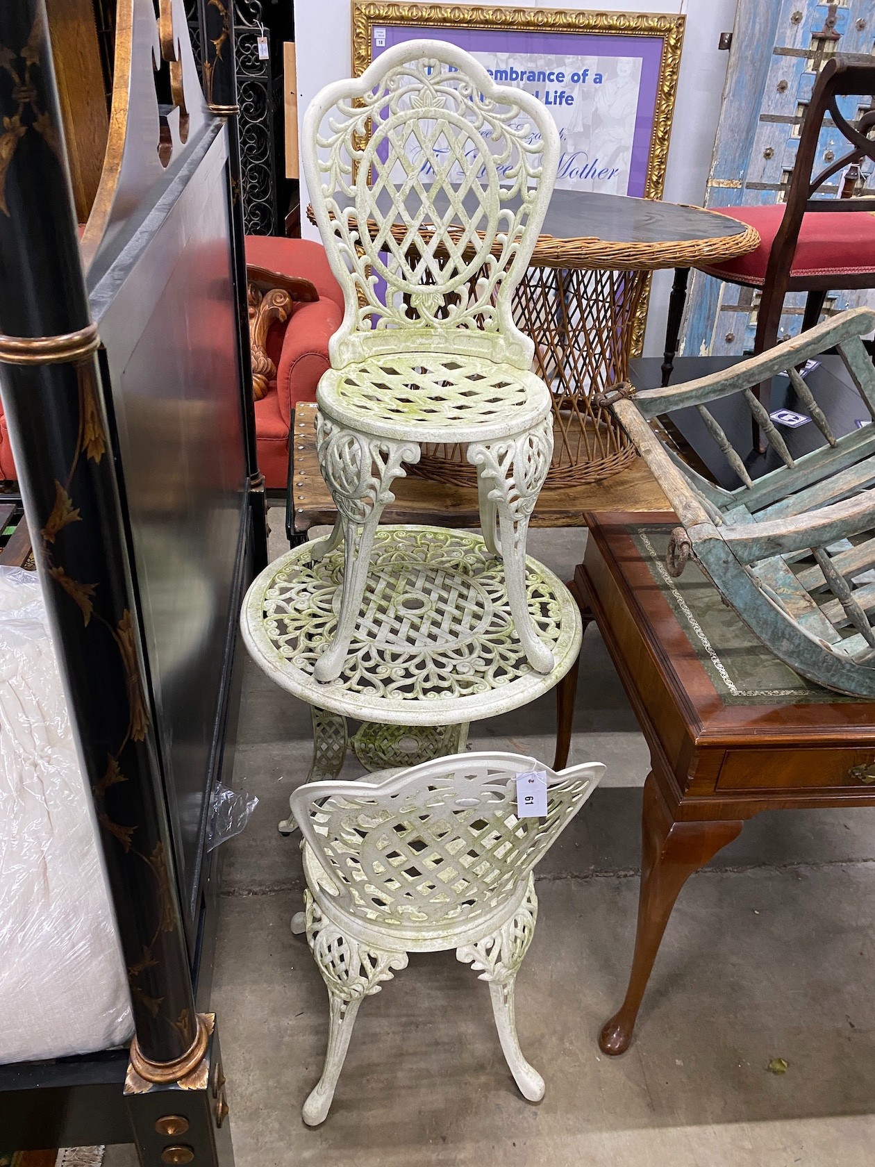 A Victorian style painted aluminum circular garden table, diameter 64cm, height 66cm and two matching armchairs